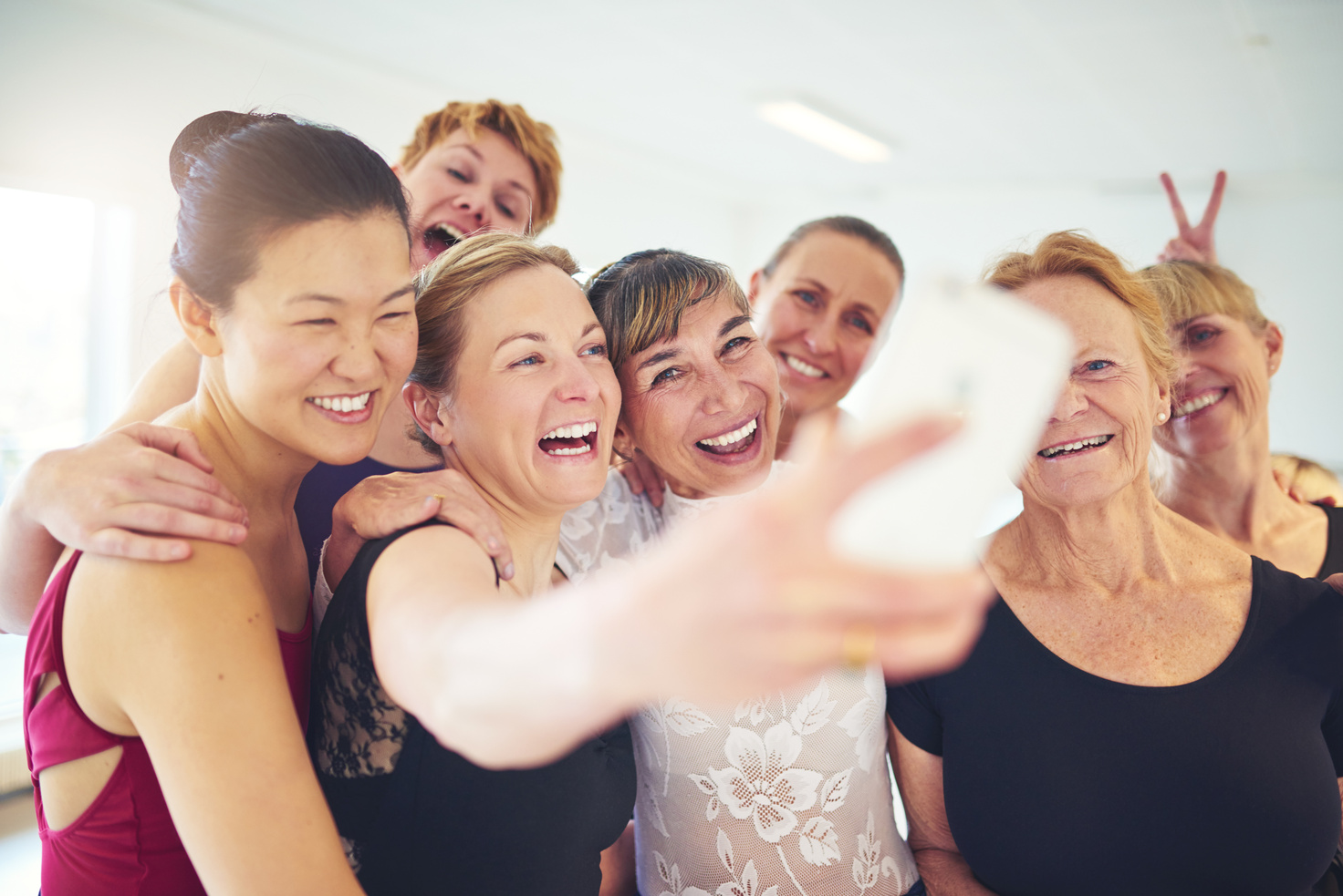 Group of Laughing Friends Taking Selfies 
